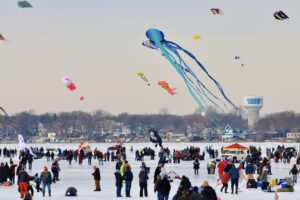 kites flying over a frozen lake