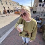 woman with coffee at a fall festival