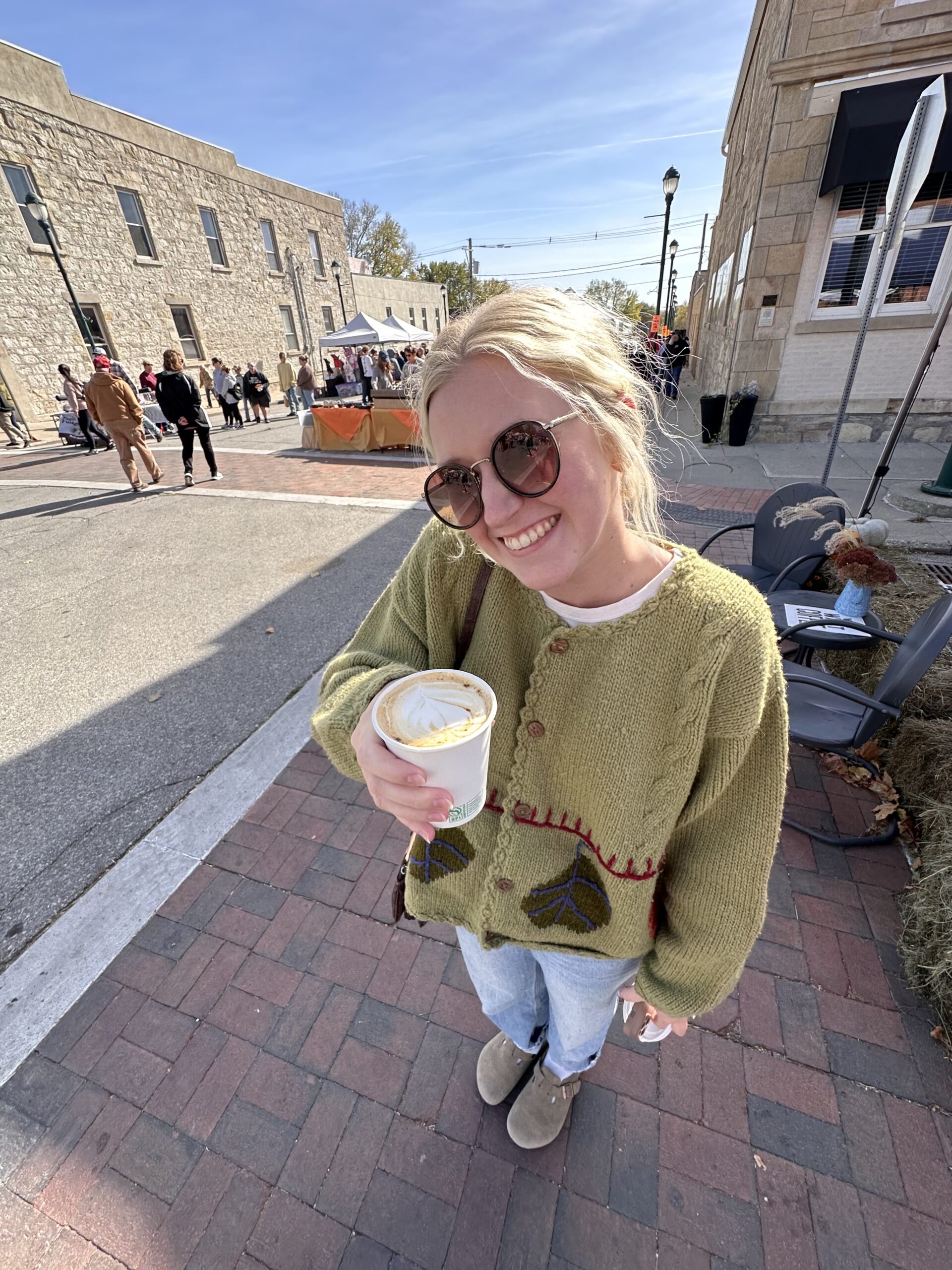 woman with coffee at a fall festival