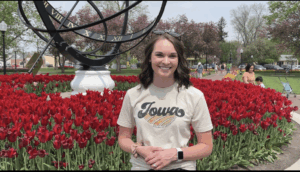 woman standing in front of red tulips