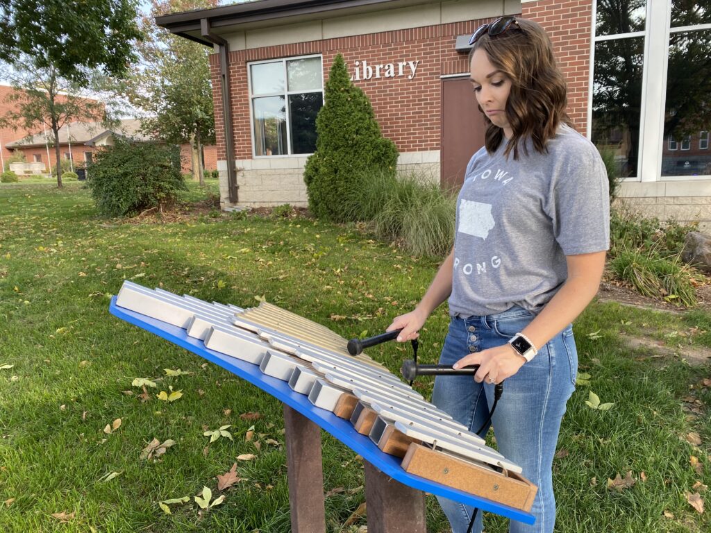 woman playing bells at a music park