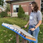 woman playing bells at a music park