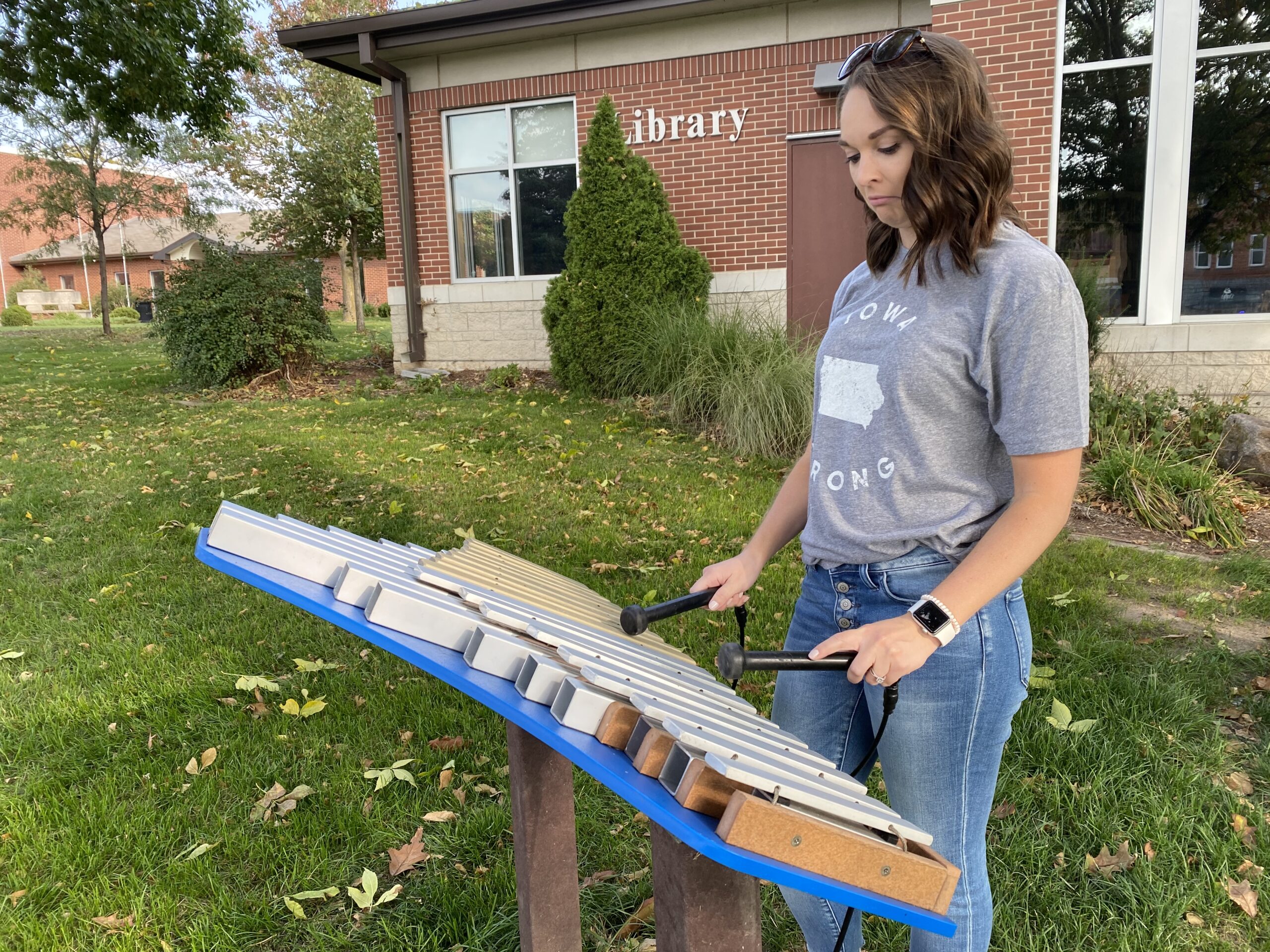 woman playing bells at a music park